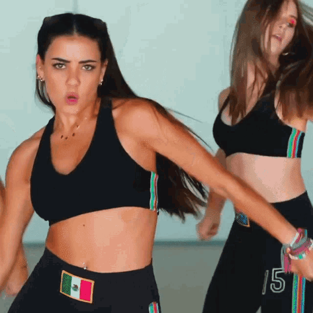 a woman in a black crop top with the number 15 on it