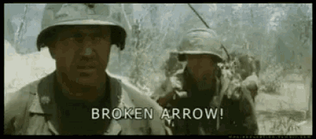 a man in a helmet is standing next to another man in a helmet .