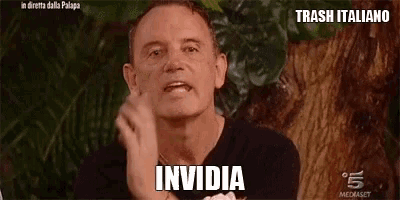 a man is making a funny face with the word invidia written on his face .