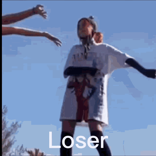 a person in a white shirt with the word loser on it