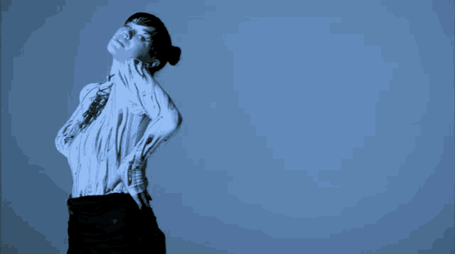 a woman wearing a white shirt with black lines on it