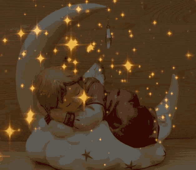 a figurine of a child sleeping on the moon
