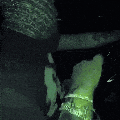 a blurry picture of a person 's face with a green light behind them