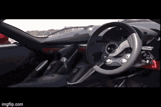 a steering wheel is shown in a car with imgflip.com at the bottom