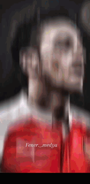 a blurred image of a man with the words fener_medya written below him