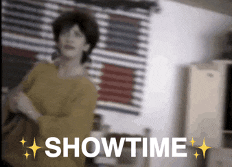 a woman in a yellow shirt is standing in front of a sign that says showtime on it