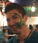 a young man with a dinosaur painted on his face