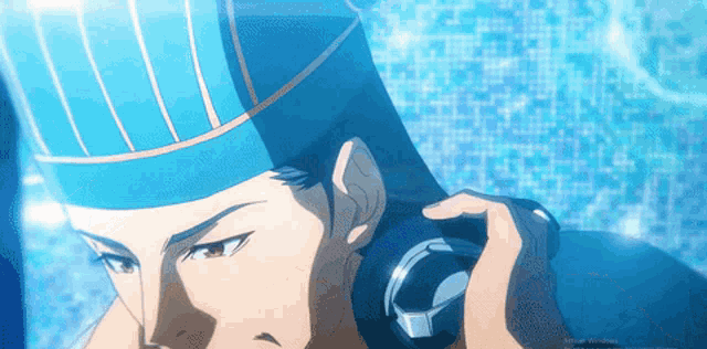 a close up of a man wearing headphones and a hat