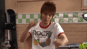 a young man wearing a white shirt that says rock