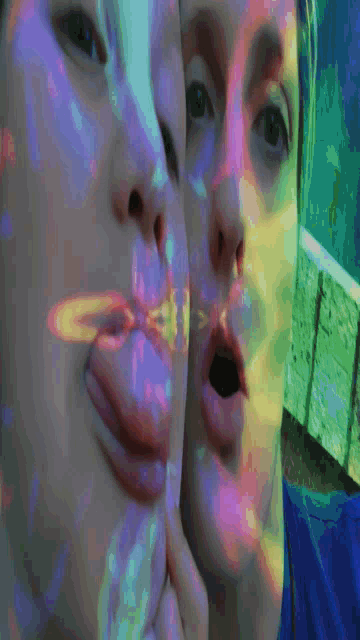 a close up of a person 's face with a rainbow of colors behind it