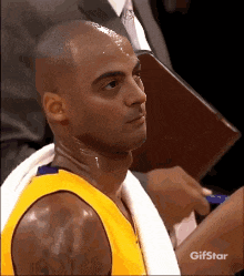 a gif of a basketball player with a towel around his neck and the words gifstar at the bottom