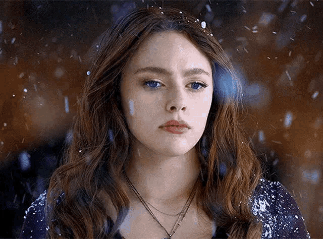 a close up of a woman 's face in the snow .