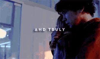 a man and woman hugging with the words " and truly " in the background