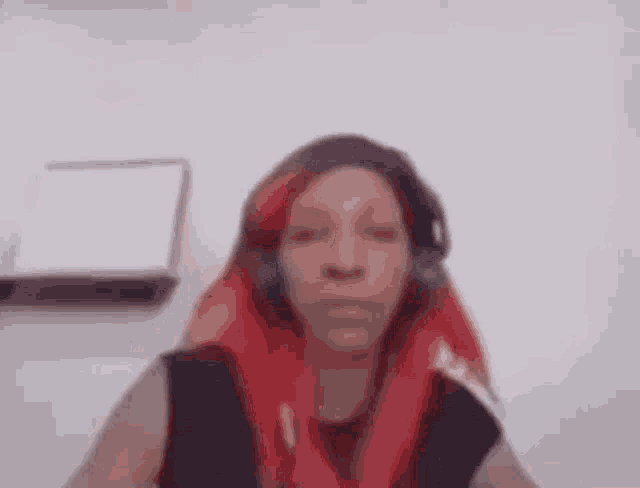 a woman with red hair and headphones is dancing with her arms in the air .