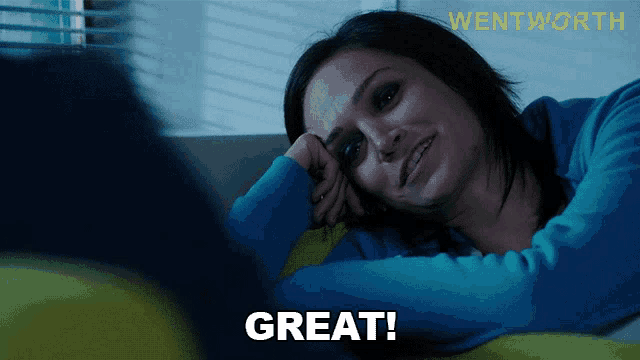 a woman is laying on a couch with the word great written on the bottom