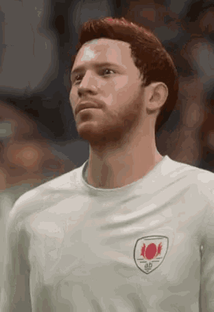 a man with a beard and red hair is wearing a white shirt with a red circle on the back .
