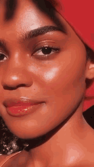 a close up of a woman 's face with a red headband on