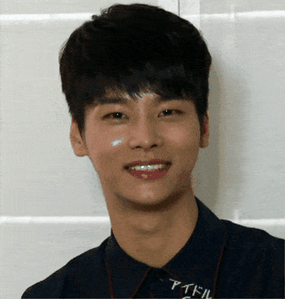 a young man wearing a shirt that says " idol " smiles for the camera