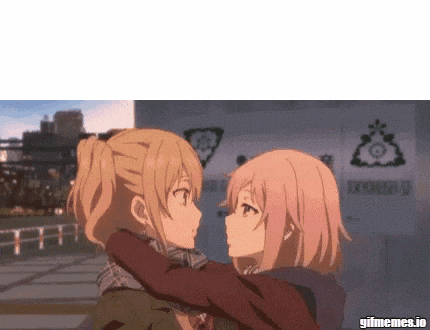 a couple of anime girls are hugging each other .