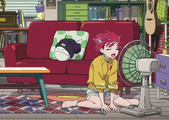 a girl is sitting on the floor next to a fan