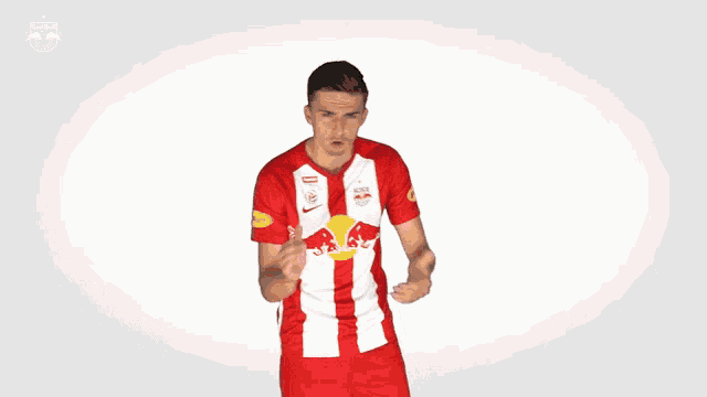 a man in a red and white jersey with a red bull on the front