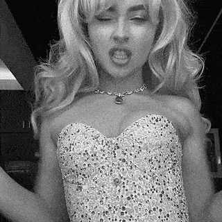 a black and white photo of a woman in a strapless dress and a necklace .