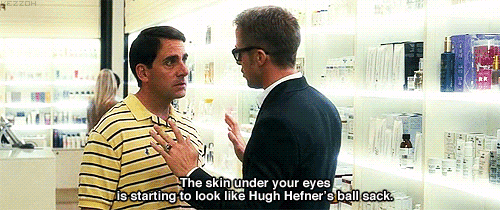two men are talking in a store with one saying " the skin under your eyes is starting to look like hugh hefner "