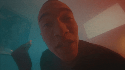 a close up of a man 's face with a light behind him