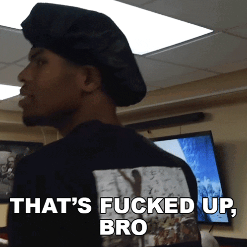 a man wearing a black hat and a black shirt that says that 's fucked up bro
