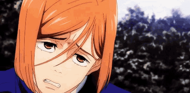 a close up of a person 's face with orange hair and a blue jacket .