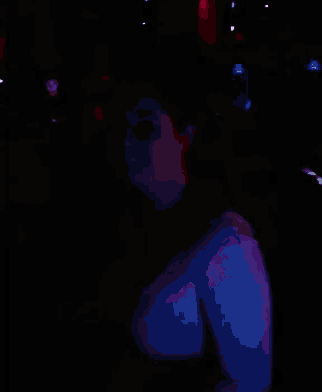 a blurry picture of a crowd of people dancing in a dark room