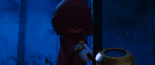 a person in a red robe is holding a lantern in the dark