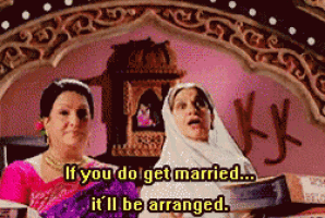a couple of women standing next to each other with the words if you do get married it 'll be arranged