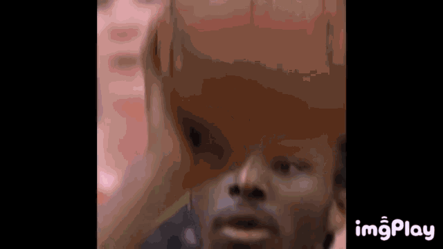 a close up of a man holding a basketball over his head