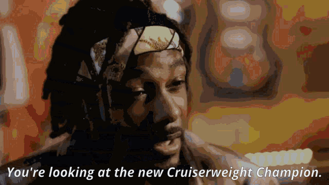a man with dreadlocks and a headband says you 're looking at the new cruiserweight champion