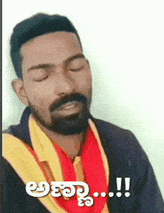 a man with a beard is wearing a yellow and red scarf around his neck and says " !! "