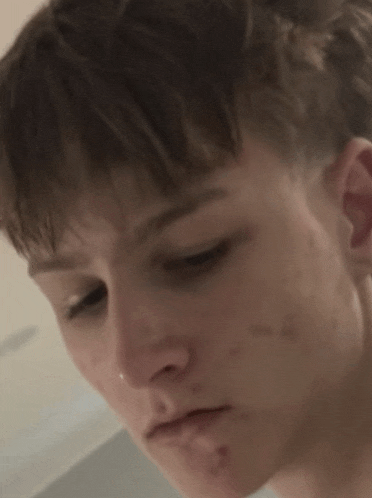 a close up of a person 's face with a nose ring