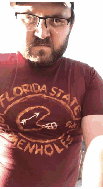 a man wearing glasses and a florida state t-shirt