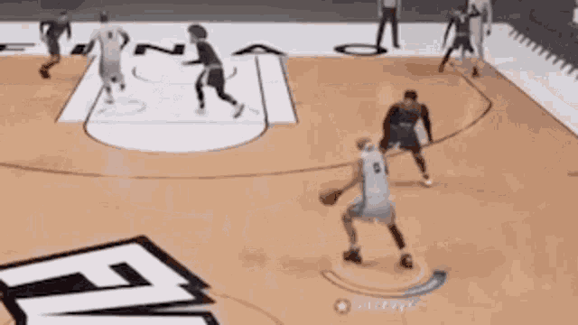 a group of basketball players are playing a game of basketball on a basketball court .