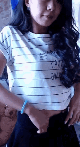 a woman is wearing a striped shirt that says yaoi on it