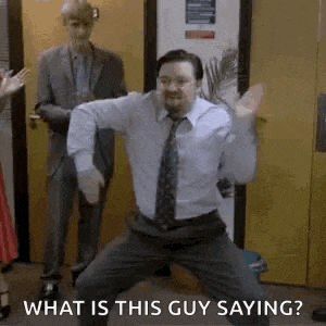 a man in a suit and tie is dancing in front of a group of people .