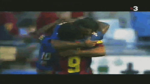 a soccer player with the number 9 on his jersey hugging another player