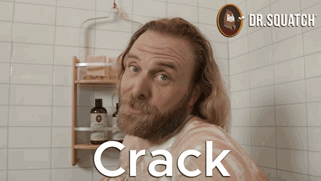 a man with a beard is taking a shower and the word crack is on the wall