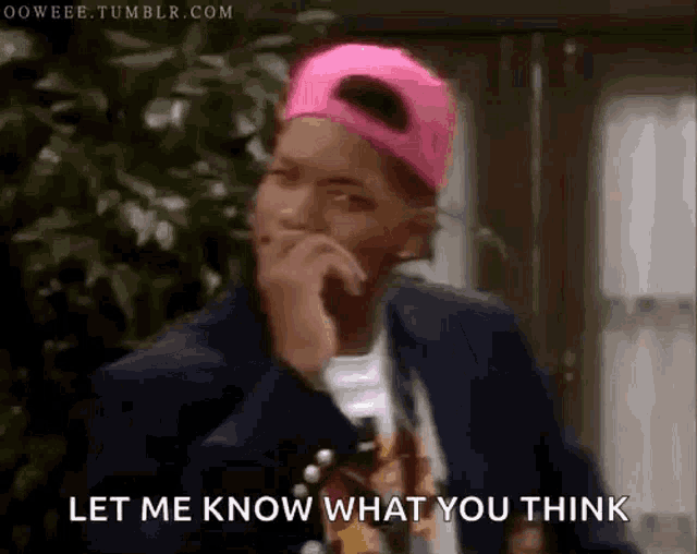 a man wearing a pink hat says let me know what you think .