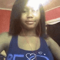 a woman wearing a blue tank top with a heart on it .