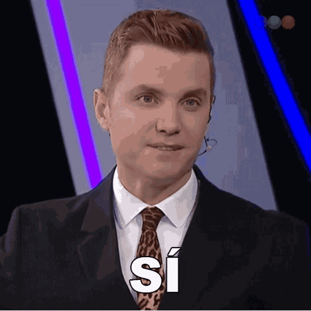 a man in a suit and tie has the word si written on his face