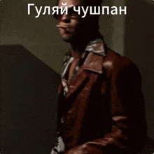 a man wearing sunglasses and a leather jacket is standing in a dark room with a caption in russian