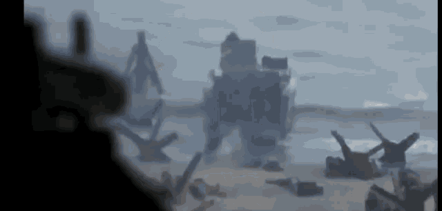 a silhouette of a man is standing on a beach next to a military vehicle .