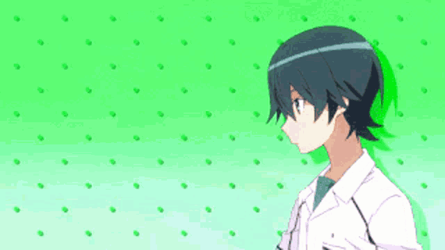 a boy with short black hair is standing in front of a green background with dots