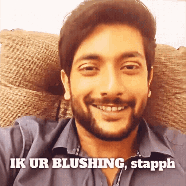 a man with a beard is smiling with a caption that says ik ur blushing stapph